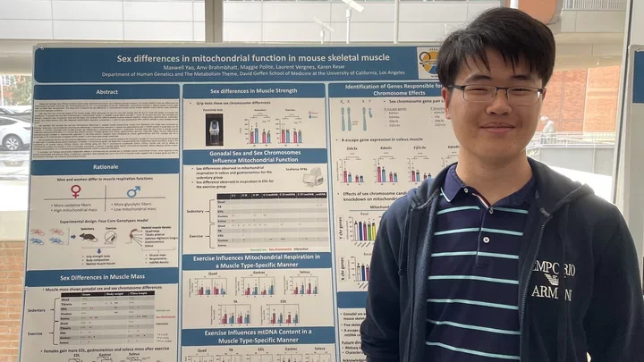 Maxwell Yao standing in front of his poster at the SCORE symposium.