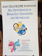 The Joint SCORE Symposium poster. It reads, "Sex Differences in Brain-Gut Disorders and Metabolism."