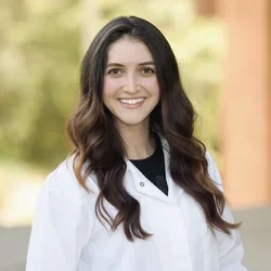 Portrait of Rebecca Hernandez wearing a lab coat.